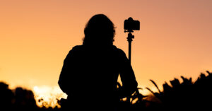 A photographer is waiting for the sun to rise.