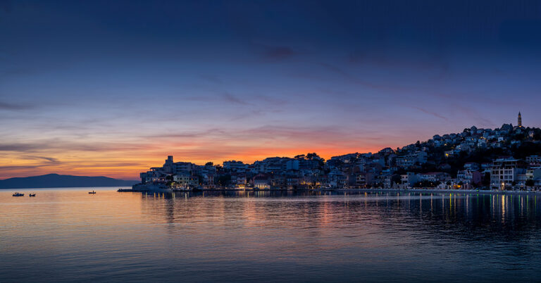 Calm sunset over a Croatian coastal village, reflecting the shift from a lively tourist spot to a tranquil community focused on fishing and olive picking.